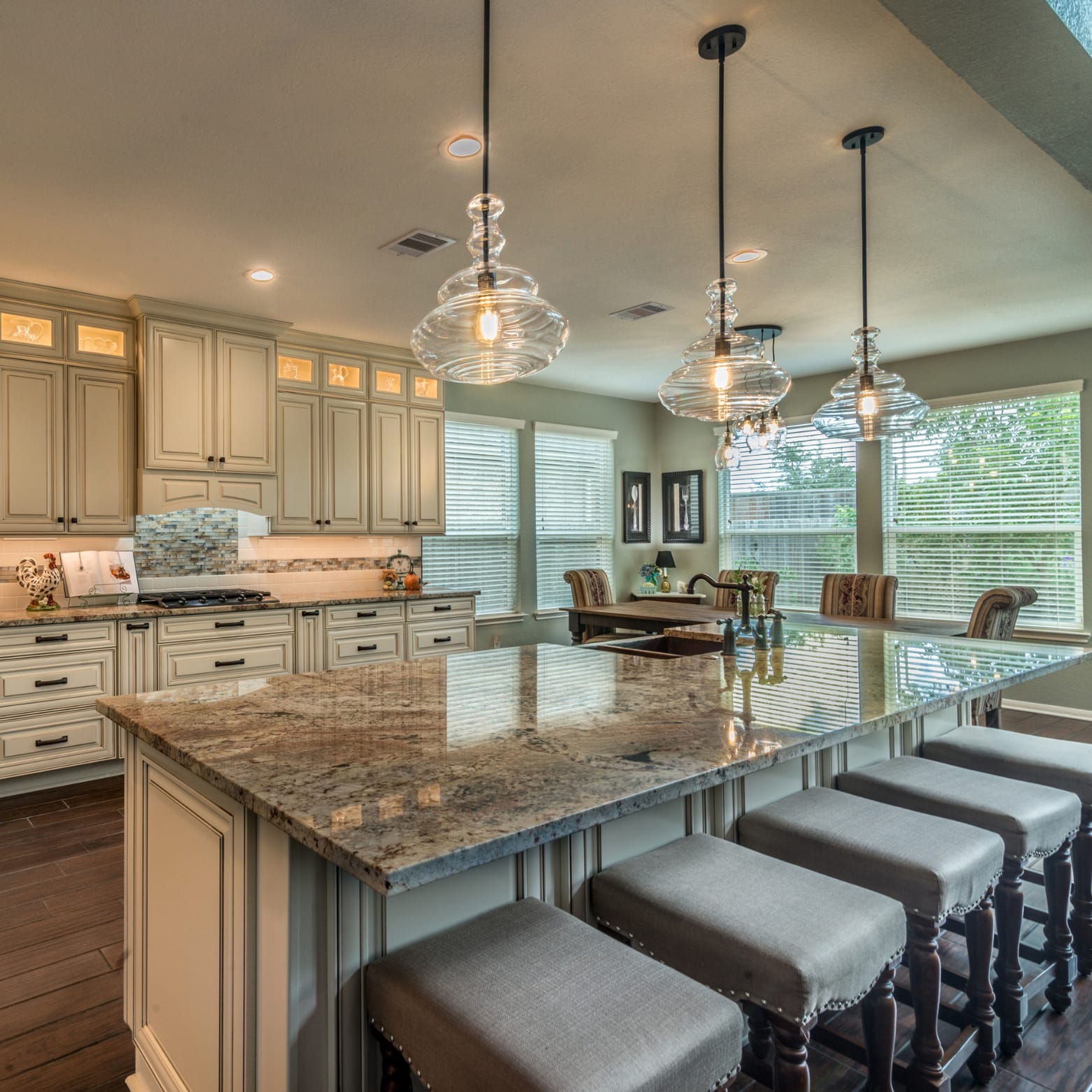 Kitchen Remodeling - Granite Countertop, White Cabinets, Hanging Lamps and More.
